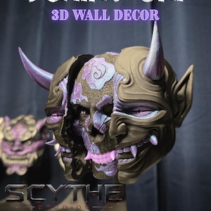 May include: A 3D printed wall decor piece titled BEHIND ONI, featuring a split mask design. The outer layer is dark brown with two horns, revealing an inner skull structure with iridescent purple and blue cloud patterns and pink teeth.