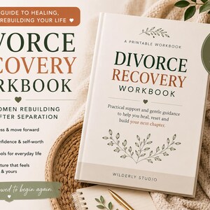 May include: A white "Divorce Recovery Workbook" with text in dark green and brown. The book offers guidance for rebuilding life after separation. A cup of coffee, a lit candle, and a plant are in the background.