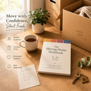 May include: A still-life scene featuring a moving home theme. A book titled "The Moving Home Workbook" sits next to a cup of tea, a houseplant, and cardboard boxes labeled "Kitchen" and "Living Room". A key with a house-shaped tag is also present.