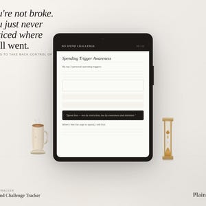May include: A digital tracker on a black tablet with the text "No Spend Challenge". The screen displays a form titled "Spending Trigger Awareness". A cup of coffee and a small hourglass are on the sides. Text reads "You're not broke. You just never noticed where it all went."