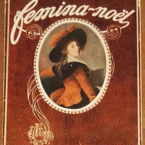 May include: A vintage advertisement with the text "Femina-noël" in white script. The image features a portrait of a person in a hat and orange attire, set within an oval frame. The background is a textured, reddish-brown.