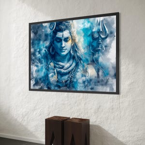 May include: A framed watercolour print of a Hindu deity, shown with a calm expression and detailed features. The artwork uses shades of blue and white, with a trident and a detailed necklace. The print is in a black frame.