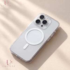 Peut inclure: Une coque de protection transparente pour iPhone Pro dotée d'un anneau de charge magnétique circulaire blanc et d'une petite barre d'alignement verticale au dos. La coque présente un cadre transparent et une découpe pour le triple objectif.