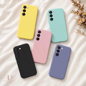 May include: Five smartphone cases in solid matte colors including yellow, mint green, light pink, black, and periwinkle blue. Each case features a vertical triple-lens camera cutout on the upper left corner and a small circular flash opening.