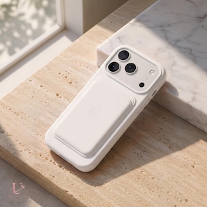 May include: A white smartphone case with a matching white magnetic battery pack attached to the back. The case features a raised camera cutout with three circular lens openings and a small flash hole. The Apple logo is embossed on the battery pack.