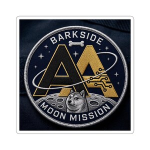 May include: A circular patch with the text "BARKSIDE MOON MISSION" and a doge-like Shiba Inu on a moon surface. The design features two stylized "A" letters, one black and one gold, with a bone and circuit board graphic.