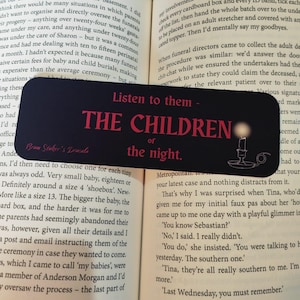 May include: Black bookmark with the text "Listen to them - THE CHILDREN of the night." The bookmark features a candle and goblet illustration. The text "Benny Stoker's Dracula" is also present.