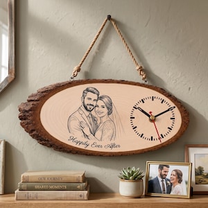 May include: An oval wood slice wall clock featuring a natural bark edge and a rope hanger. The face displays a black line-art illustration of a couple and the text "Happily Ever After" alongside a clock dial with black hands and a red second hand.