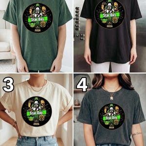 May include: Four t-shirts in different colors: green, black, cream, and gray. Each shirt features a circular graphic with the text "Star Day" and the year "2026". The graphic includes images of characters and symbols.