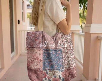 May include: A patchwork tote bag with floral patterns in pink, blue, and brown hues. The bag features a beige strap and the text "faith over fear" in a cursive font. The bag is carried over the shoulder.