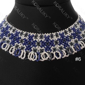 May include: A white, blue, and gray beaded choker necklace with a fringe design. The necklace is on a black mannequin bust. #6