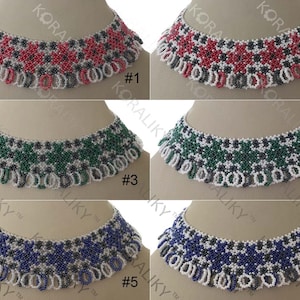 May include: Six beaded necklaces with different colored patterns. The necklaces are white with red, green, blue, and black accents. The necklaces are numbered 1 through 6.