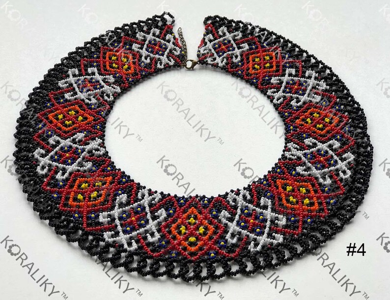 May include: A colourful beaded necklace featuring a geometric design in red, white, black, and yellow. The necklace has a scalloped edge and a clasp. The text "#4" is visible on the right side of the image.