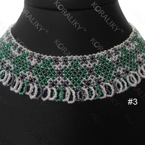May include: A beaded necklace with a green, white, and black geometric pattern. The necklace is on a black background and has a tag with the number "#3" on it.