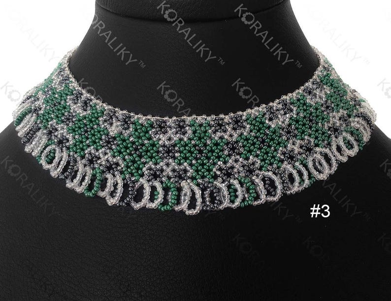 May include: A beaded necklace with a green, white, and black geometric pattern. The necklace is on a black background and has a tag with the number "#3" on it.