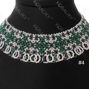 May include: A white, green, and black beaded choker necklace. The necklace has a geometric pattern and is displayed on a black mannequin.