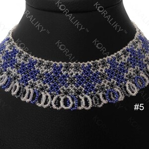 May include: A beaded necklace with a geometric pattern in shades of blue, gray, and white. The necklace is on a black background and has a fringe-like design at the bottom. #5