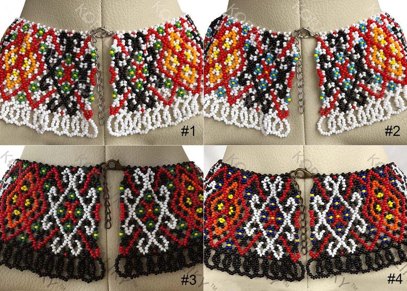 May include: Four beaded collar necklaces with detailed patterns. Each necklace uses red, white, black, and yellow beads. The necklaces are displayed on a mannequin, highlighting their design and craftsmanship. The necklaces are approximately 15 cm in length.