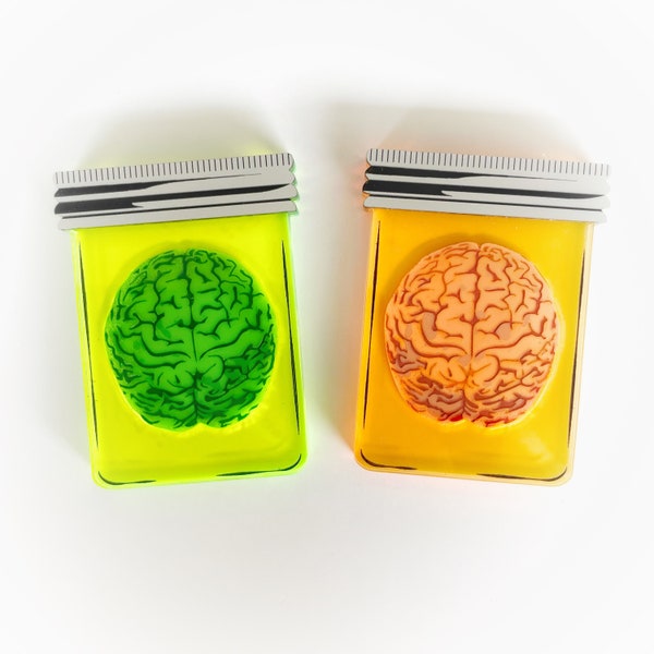 Cerveau vert fluo et orange dans une broche en pot en couches d'acrylique découpé au laser