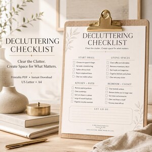 May include: A wooden clipboard holding a white paper decluttering checklist with black text. The checklist features sections for start small, living spaces, kitchen, bath, bedroom, and closet, with checkboxes and a section to list items to let go of.