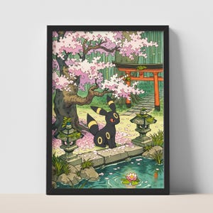 May include: A framed wall art print featuring a black creature with yellow rings sitting on a stone bridge. The scene includes a pink cherry blossom tree, a red torii gate, stone lanterns, and a pond with a single pink water lily flower.