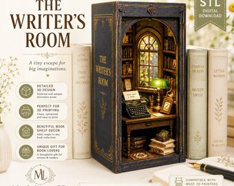 May include: A digital 3D printable book nook diorama titled The Writer's Room, featuring a miniature study with a desk, typewriter, green lamp, and bookshelves inside a dark blue book-shaped frame with gold lettering and ornate details.