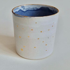 Handmade porcelain cup with golden dots