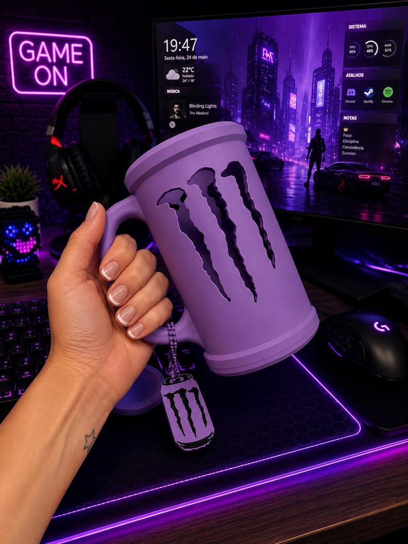 May include: A matte lavender mug featuring a large, vertical, three-clawed cutout design on the front. A small, matching lavender-colored metal tag shaped like a beverage can with the same three-clawed logo hangs from the handle by a chain.