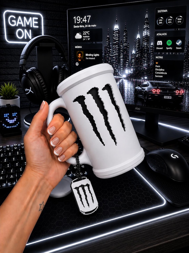 May include: A white ceramic mug featuring a large, vertical, claw-mark cutout design on the front. A small, black, rectangular metal tag with a white claw-mark logo hangs from the handle by a black beaded chain, matching the mug's aesthetic.
