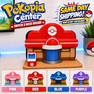 May include: A red, white, and tan plastic dock holder for a gaming console, shaped like a building with a central dome and a small side kiosk. The structure features a red roof, tan walls, and a blue door. Four color variations are shown below.