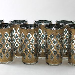 May include: Set of eight tall, clear glass highball glasses with a gold and teal geometric pattern.