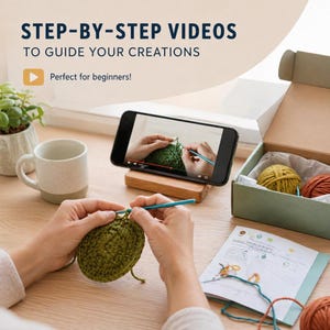 May include: A person crocheting with green yarn, following a video tutorial on a smartphone. The phone rests on a wooden stand. The image includes text: "STEP-BY-STEP VIDEOS TO GUIDE YOUR CREATIONS". A box with yarn balls and a mug are also visible.
