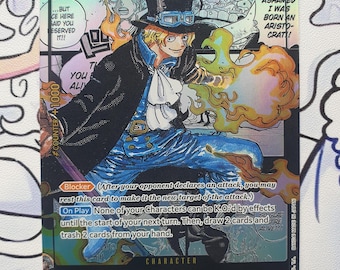 May include: A collectible trading card featuring the character Sabo from the Dressrosa/Revolutionary Army. The card has a colorful illustration of Sabo with text and a counter value of +1000. The card has a special 6000 value.