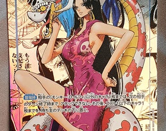 May include: A collectible trading card featuring a character from the One Piece anime. The card showcases a woman in a pink dress with a snake-like creature. The card has Japanese text and a gold foil background.
