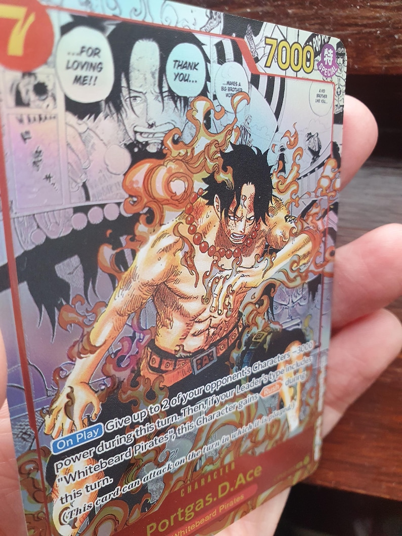May include: A trading card featuring the character Portgas D. Ace from the "One Piece" series. The card has a vibrant design with Ace surrounded by flames. The card's text includes "7000" and "Whitebeard Pirates."