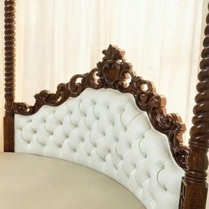 Headboard of luxury round canopy bed featuring a solid teak four-poster frame, sheer white curtains, and white button-tufted upholstery.
