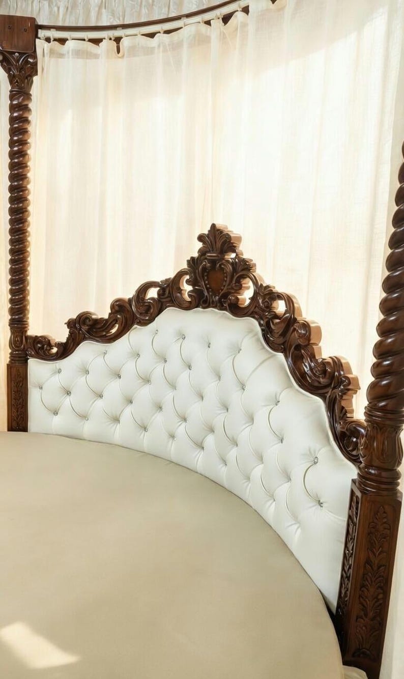 Headboard of luxury round canopy bed featuring a solid teak four-poster frame, sheer white curtains, and white button-tufted upholstery.