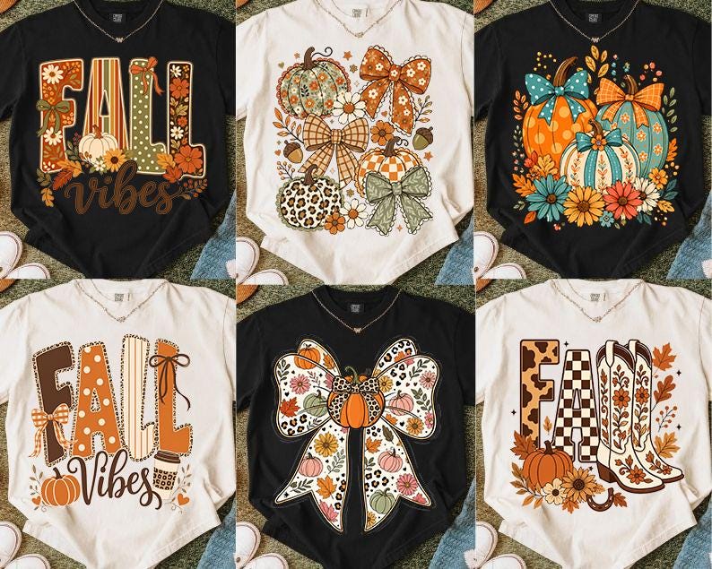 May include: A collection of six short-sleeve t-shirts in black and cream, featuring various graphic prints including pumpkins, bows, flowers, cowboy boots, and the text FALL VIBES, displayed in a grid layout on a textured surface.