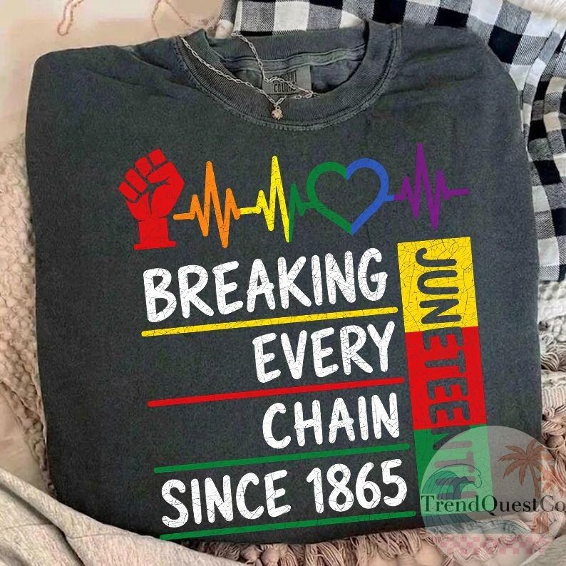 May include: Dark gray t-shirt with the text "BREAKING EVERY CHAIN SINCE 1865" and "JUNETEENTH". The design includes a red fist, a rainbow heartbeat, and a green and blue heart.