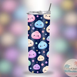 May include: A stainless steel tumbler with a navy blue background, patterned with smiling dumplings and stars in pastel colours. It has a silver lid and a silver straw.