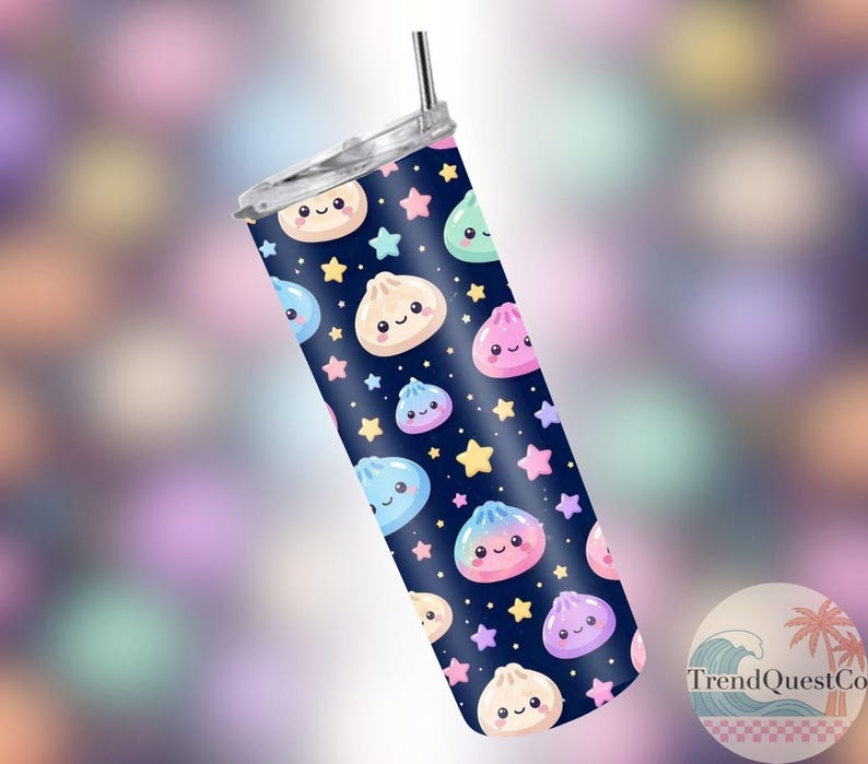 May include: A navy blue tumbler with a silver lid and straw. The tumbler features a pattern of smiling dumplings and stars in various colours. The tumbler is cylindrical in shape.
