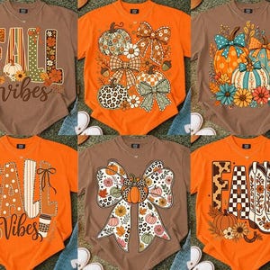 May include: A collection of six short-sleeved t-shirts in brown and orange, featuring various graphic prints including pumpkins, bows, flowers, cowboy boots, and the text FALL VIBES, displayed in a grid layout on a textured surface.