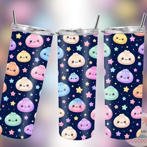 May include: Three stainless steel tumblers with a navy blue background, patterned with smiling dumplings and stars in various colours. Each tumbler has a silver lid and a straw.
