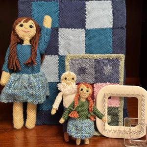 May include: A collection of three knitted dolls and two blankets with a pin loom weaving pattern. The text reads: Dolls and Blankets, Pin Loom Weaving Pattern, Large Girl & Blanket - 4" squares only, Little Man - 2" squares only.