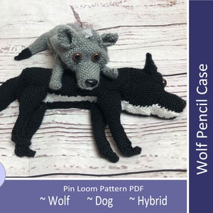 May include: A crochet wolf pencil case with a smaller wolf on top. The case is black with white accents and the smaller wolf is gray with brown eyes. The text "Wolf Pencil Case" is in the upper right corner of the image. The text "Looms Needed: Square: 4", 2", 1" and Rectangles: 2"x4", 1"x4" is in the lower right corner of the image.