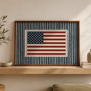 May include: Framed print of the American flag. The flag features red and white stripes and a blue canton with white stars. The flag is set against a blue and white striped background, framed in a brown wooden frame.