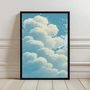 Puede incluir: Una lámina de arte mural enmarcada que presenta una ilustración estilizada de nubes blancas esponjosas sobre un cielo azul claro texturizado. La obra está encerrada en un marco rectangular negro fino con un efecto de impresión de puntos.