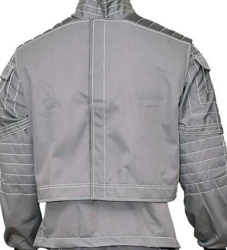 May include: A grey jacket featuring a high collar and long sleeves with horizontal white stitching details. The back panel has a central vertical seam, and the shoulders and sleeves include structured quilted sections with white topstitching.
