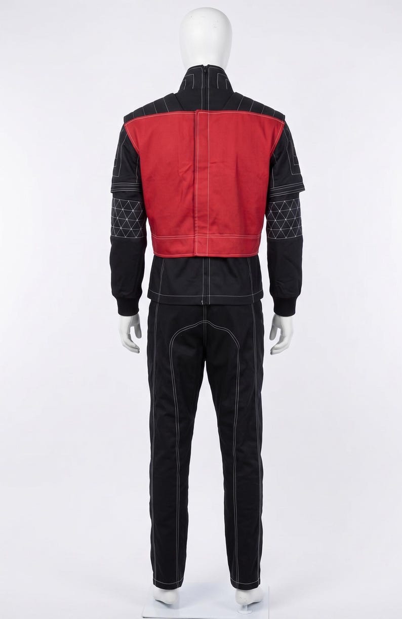 May include: A black and red jumpsuit featuring a high collar, long sleeves with white geometric grid stitching, and a solid red back panel. The garment includes white contrast stitching throughout, a full-length back zipper, and long black trousers.