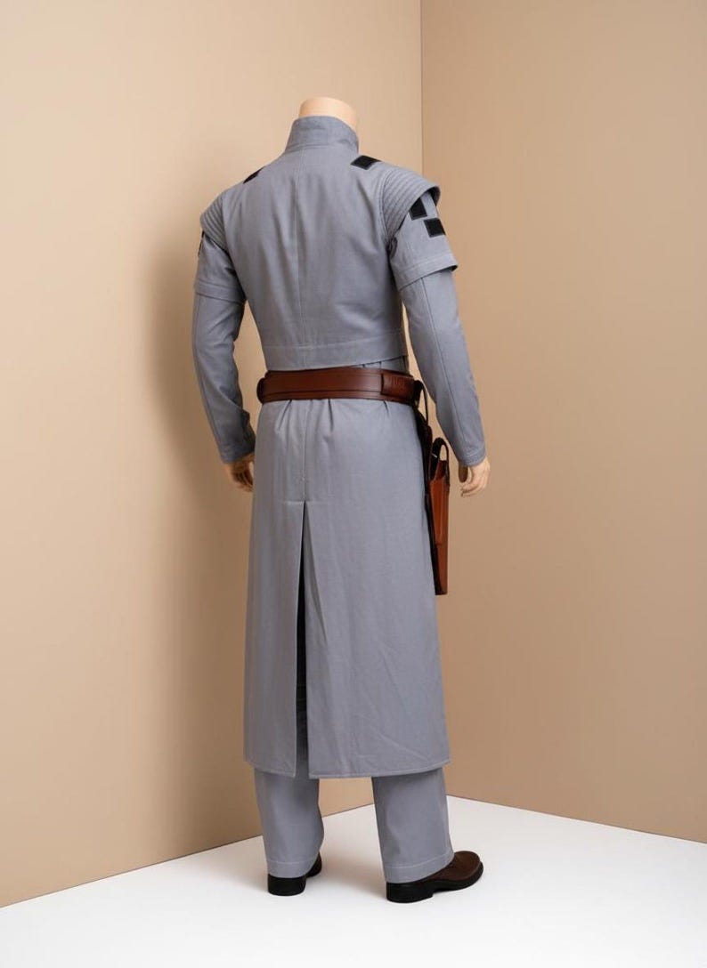 May include: A set of three ceramic mugs with a speckled, matte finish. The mugs are in shades of cream, light gray, and dark gray. Each mug has a simple, minimalist design and a rounded handle. The mugs are likely for coffee or tea.